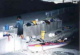 Photo:Unload the goods from a kayak at port. 